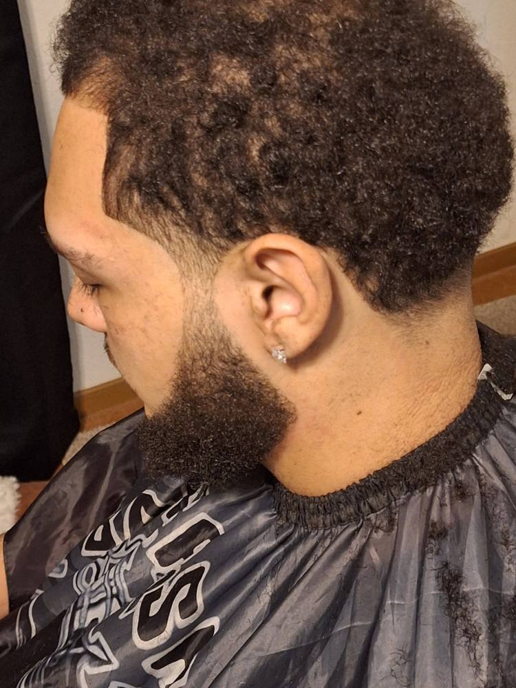 Close-up of a shaped beard and faded sideburn