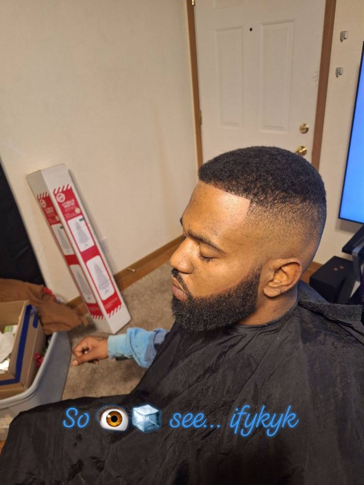 Bald fade blended into a full, shaped beard