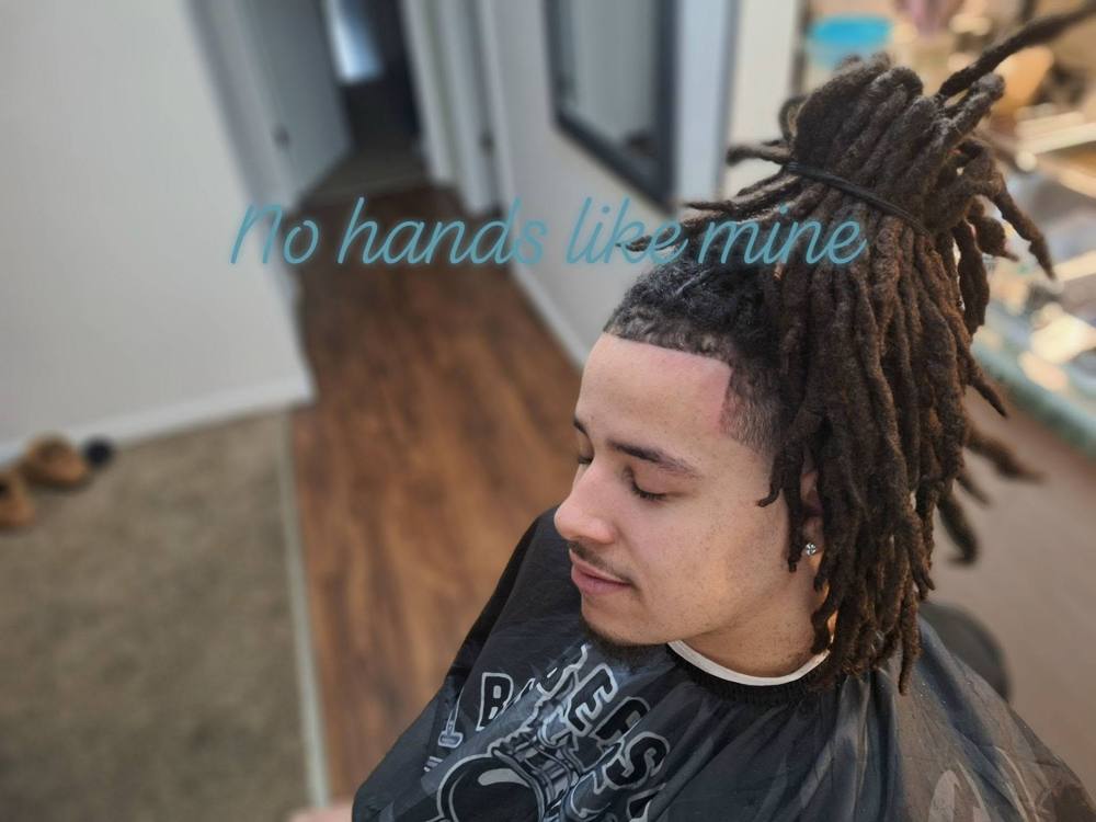 Locs pulled up with a crisp line-up and taper on the sides